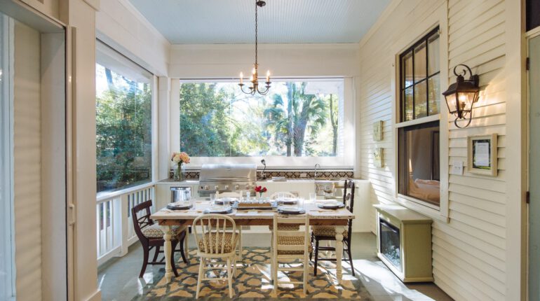 Southern home back porch with dining table and motorized Phantom retractable screens