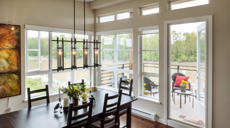 Dining room with Phantom retractable screens on open door leading to balcony