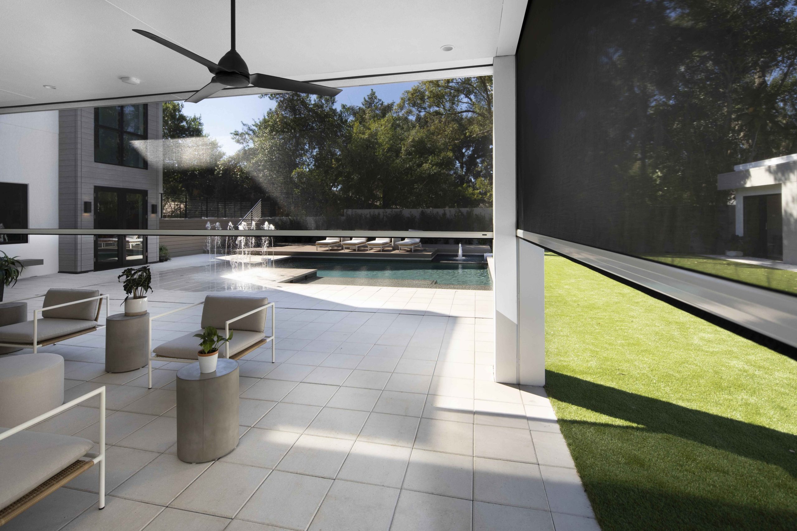 Luxury poolside patio wth retractable motorized screens